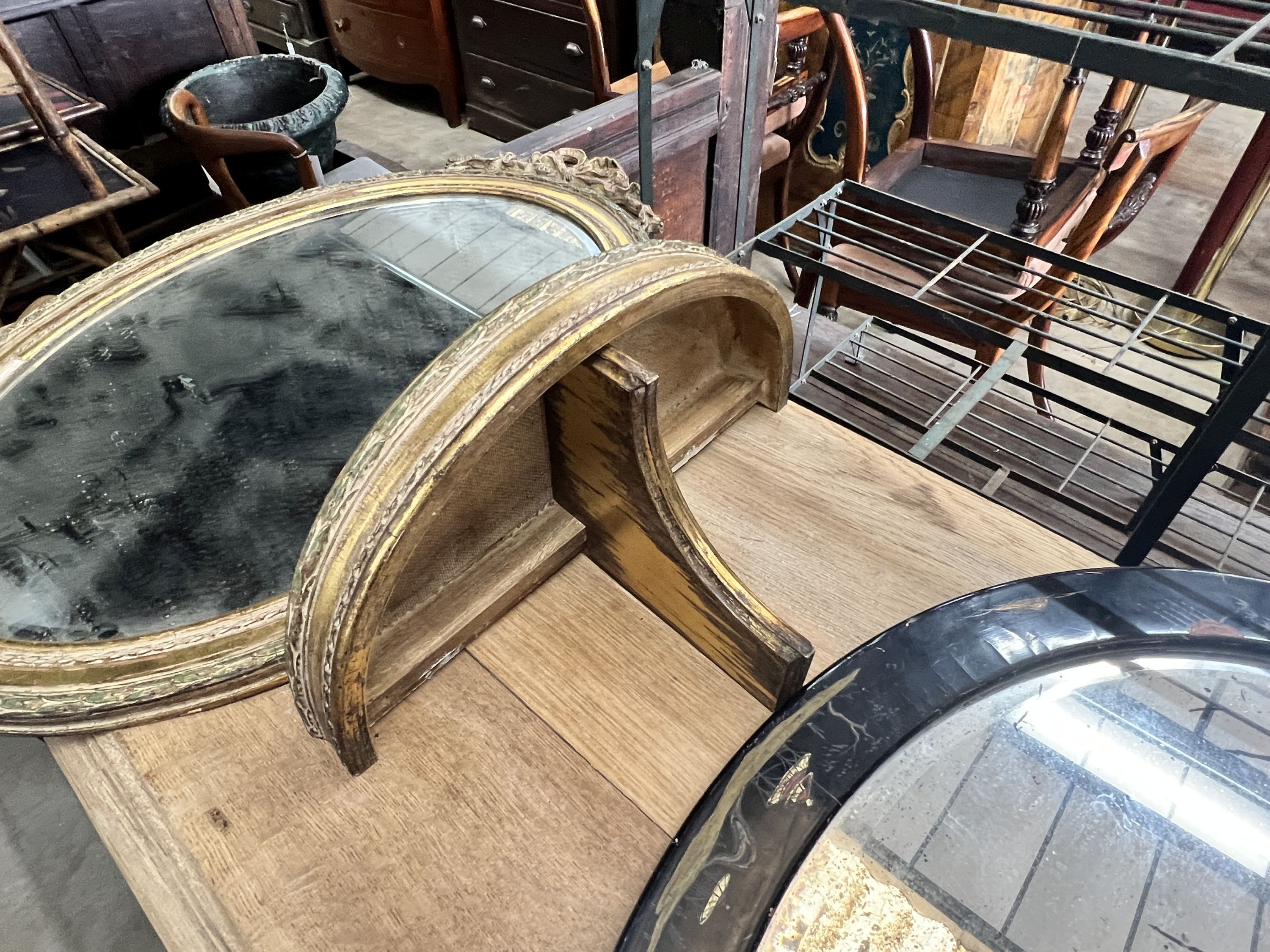 An oval gilt framed wall mirror, height 70cm, a matching wall bracket and an oval chinoiserie lacquered wall mirror, height 48cm